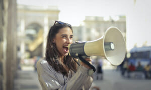  a woman shouting on a megaphone
